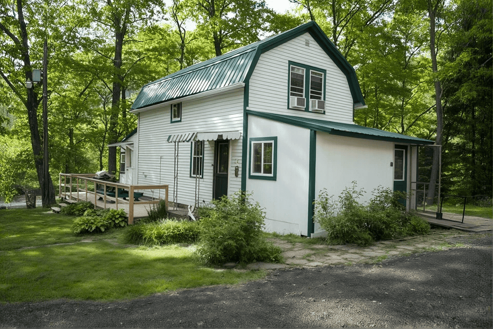 White cottage with green roof