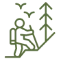 Hiker climbing mountain with birds